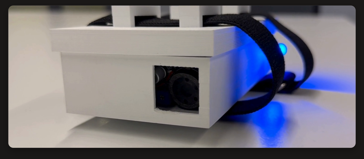The Conductor Simulator box up close, blue LED lit — a still from the prototype demo