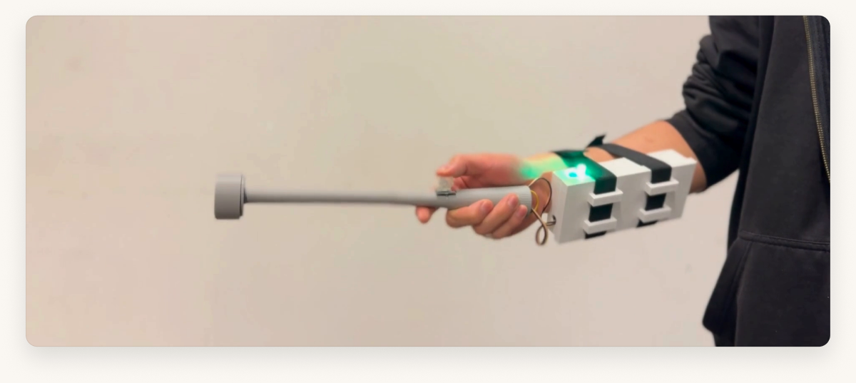 The Conductor Simulator in use — a hand sweeps the baton while the wristband box on the forearm glows green
